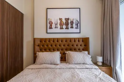 a bedroom with a bed and a picture on the wall at stylish 2 bedroom Apt in Business bay Dubai in Dubai
