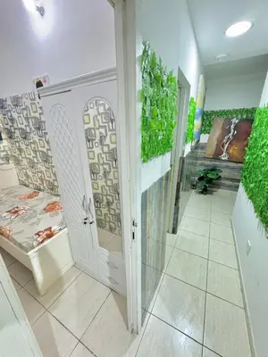 a room with a hallway with a door and plants at Cool valley homes in Dubai