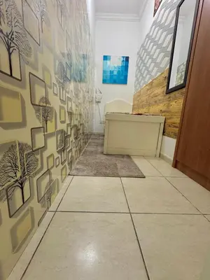 a hallway with a wall with pictures on it at Cool valley homes in Dubai