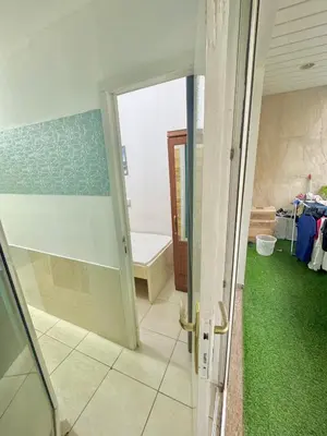 an open door to a bathroom with green carpet at Cool valley homes in Dubai