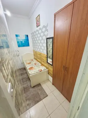 a bathroom with a bench and a wooden door at Cool valley homes in Dubai