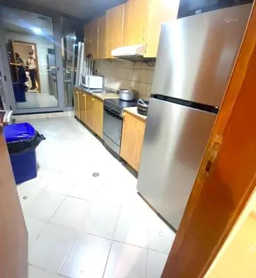 a kitchen with a stainless steel refrigerator in it at Lavish Double Partition Room in Barsha Heights in Dubai