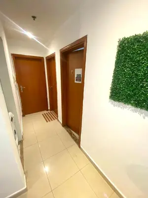 a hallway with a green plant on a wall at Niche Double Partition Room in Tecom Near Metro in Dubai