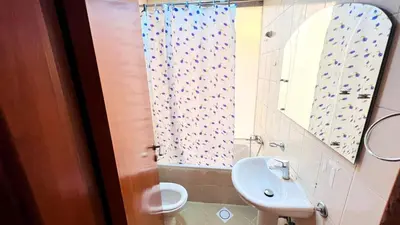 a bathroom with a sink and a toilet and a mirror at Niche Double Partition Room in Tecom Near Metro in Dubai