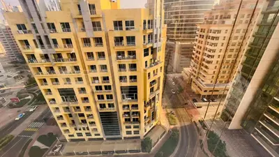 an overhead view of a tall yellow building at Niche Double Partition Room in Tecom Near Metro in Dubai