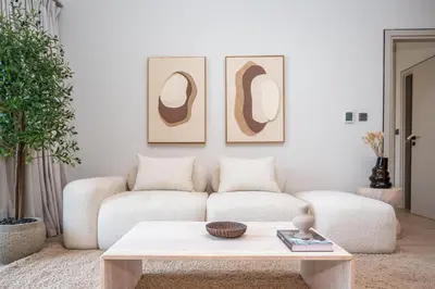 a living room with a couch and a coffee table at Modern 1-Bedroom Retreat in MBR City in Dubai