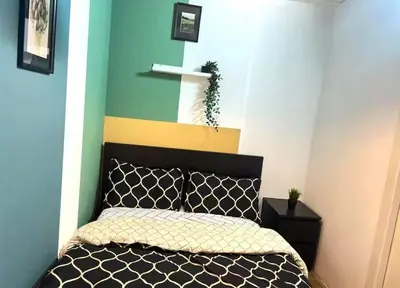 a bedroom with a bed and a blue wall at Twin Bed Partition Room Near ICM Metro in Dubai