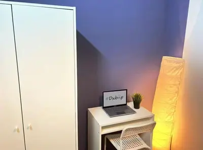 a laptop computer sitting on top of a table at Twin Bed Partition Room Near ICM Metro in Dubai
