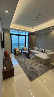 a living room with two couches and a table at Luxe 3BDR Panoramic Burj Khalifa Views Business Bay in Dubai