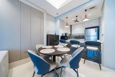 a dining room with a table and chairs at Luxe 3BDR Panoramic Burj Khalifa Views Business Bay in Dubai
