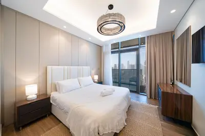 a bedroom with a large bed and a large window at Luxe 3BDR Panoramic Burj Khalifa Views Business Bay in Dubai