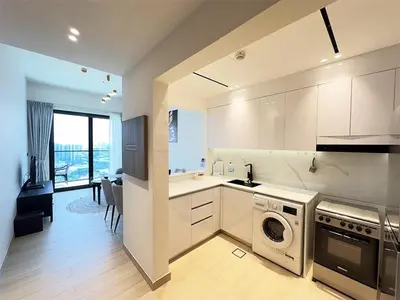 a kitchen with a washer and dryer in a room at Luxurious new 1 bedroom with Balcony and New Building in Dubai