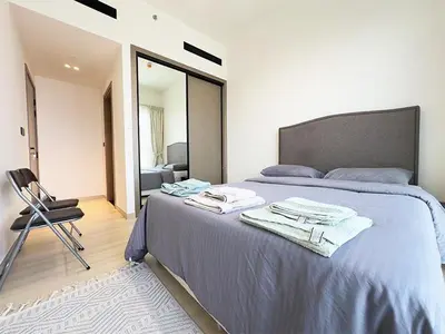 a bedroom with a bed with towels on it at Luxurious new 1 bedroom with Balcony and New Building in Dubai