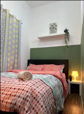 a person laying on a bed in a bedroom at Double Bed Partition Room Near Mashreq Metro in Dubai