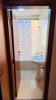 a bathroom with a sink and a shower at Bagpack Double Partition Room in Tecom Near Metro in Dubai