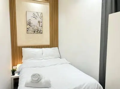 a bedroom with a bed with a towel on it at Adventurers Partition Room in Barsha Heights in Dubai