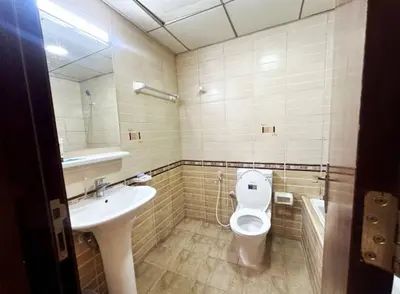 a bathroom with a toilet and a sink at Adventurers Partition Room in Barsha Heights in Dubai