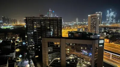 a view of a city at night with buildings at Adventurers Partition Room in Barsha Heights in Dubai