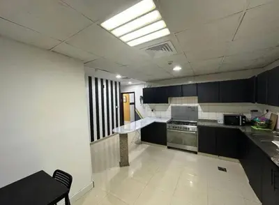 a kitchen with black and white cabinets and a sink at Loft Room in Al Barsha 1 Near MOE Metro in Dubai