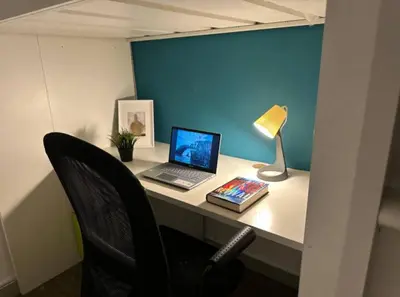 a desk with a laptop computer and a lamp on it at Loft Room in Al Barsha 1 Near MOE Metro in Dubai