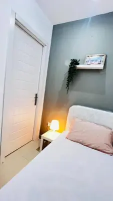 a bedroom with a white bed and a white door at Compact Partition Room in Barsha in Dubai