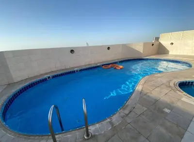 a large blue swimming pool in a building at Newly Furnished Room in Barsha 1 Near MOE in Dubai