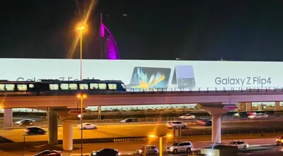 a billboard with a bus on a highway at night at Newly Furnished Room in Barsha 1 Near MOE in Dubai
