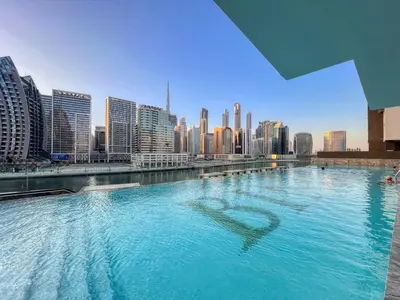a large swimming pool with a view of a city at AWS Holiday Homes - Dreamful Views of the Burj in Dubai