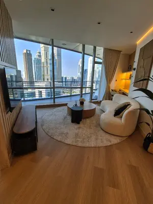 a large living room with a view of a city at 85m2 En Suite, DIFC in Dubai