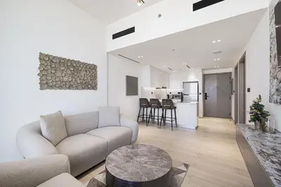 a living room with a couch and a table at Daniels Stylish 1BR Apartment with Al khail View in Dubai