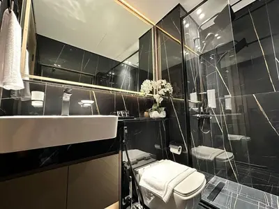 a bathroom with a white toilet and a sink at New 1br Apt Jvc Pool View, Balcony & Parking in Dubai