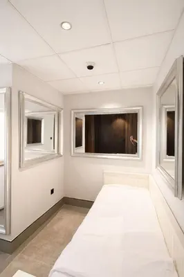 a room with two windows and a white couch at Modern Marina Escape 4BR Family Retreat at JBR in Dubai