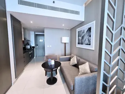 a living room with a couch and a table at Damac Maison Prive - Blue Ocean Holiday Homes in Dubai