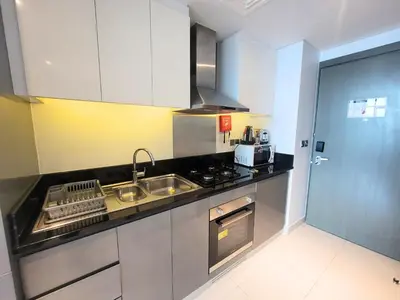 a kitchen with a sink and a stove at Damac Maison Prive - Blue Ocean Holiday Homes in Dubai