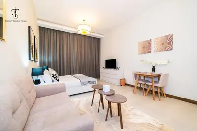 a living room with a couch and a bed at Splendid City Views Studio- SOL BAY Business Bay in Dubai
