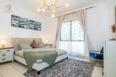 a bedroom with a bed and a window at Cozy Old Town 2-Bed Apartment with Burj Khalifa Views 202RH-2 in Dubai
