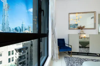 a room with a window with a view of a city at Cozy Old Town 2-Bed Apartment with Burj Khalifa Views 202RH-2 in Dubai