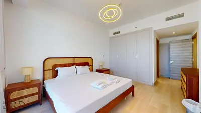 a bedroom with a bed with two towels on it at Spacious 3BR Apartment in Dubai