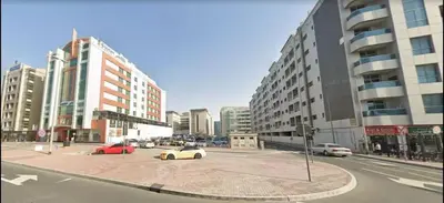 a city intersection with cars on a street with buildings at Partitioned Single Room in Al Barsha 1 Near Metro in Dubai