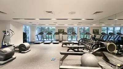 a gym with several treadmills and cardio machines at Luxe 1BR with Full Burj Views and Dubai Mall Access in Dubai