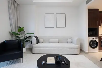a living room with a couch and a table at Luxe 1BR with Full Burj Views and Dubai Mall Access in Dubai