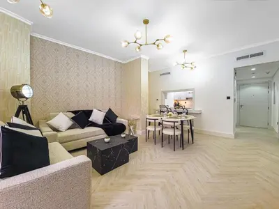 a living room with a couch and a table at Luxury 2-bed Condo Full Burj Khalifa Lights View! in Dubai