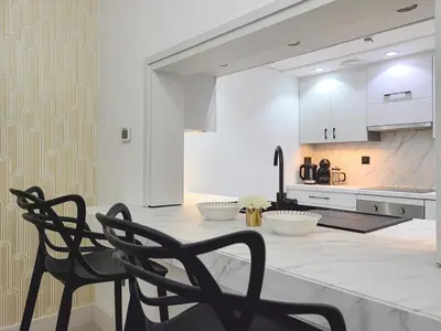 a kitchen with a table and two chairs in a kitchen at Luxury 2-bed Condo Full Burj Khalifa Lights View! in Dubai