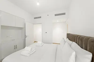 a bedroom with a white bed with white pillows at Elegant 2BR in Downtown Dubai l Walk to Dubai Mall in Dubai
