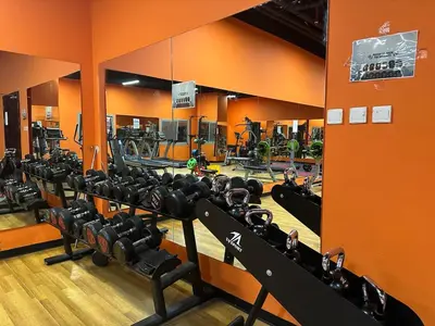 a gym with a row of treadmills and weights at Cozy Studio- Dubai Marina in Dubai