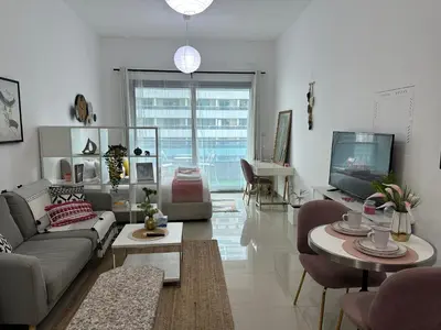 a living room with a couch and a tv at Studio Apartment- Dubai Marina in Dubai