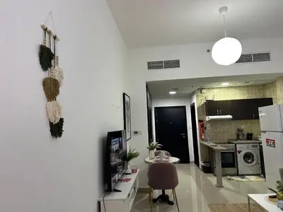 a living room with a kitchen and a dining room at Studio Apartment- Dubai Marina in Dubai