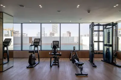 a gym with several exercise equipment in a building at Modern & Elegant 1br Apartment In Jvc in Dubai