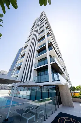 a tall white building with a lot of windows at Chic Urban 1br In Jvc With Modern Amenities in Dubai