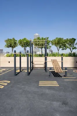 a park with a bench and a swing at Chic Urban 1br In Jvc With Modern Amenities in Dubai